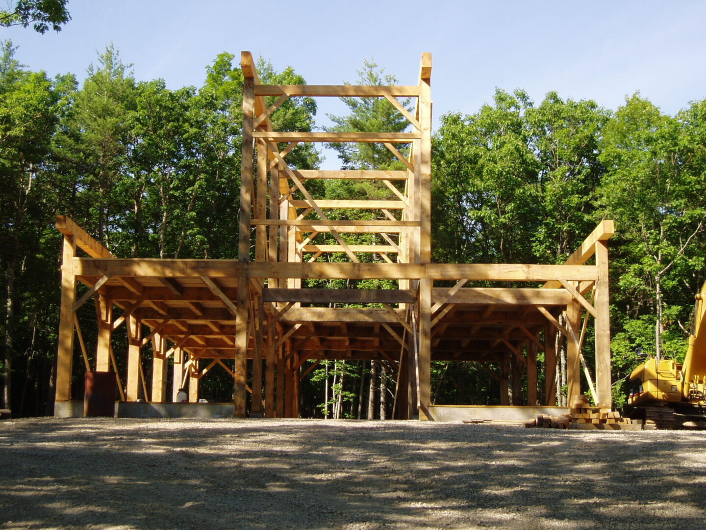 A wooden structure in the middle of a forest.